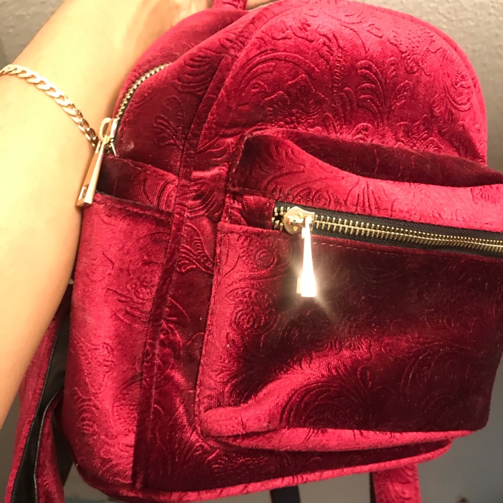Burgundy /purple mini backpack.
